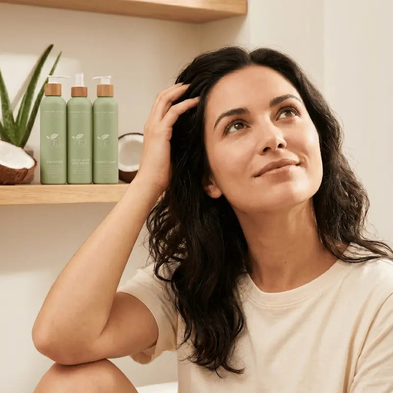 woman with the three green long and strong bottles in the background