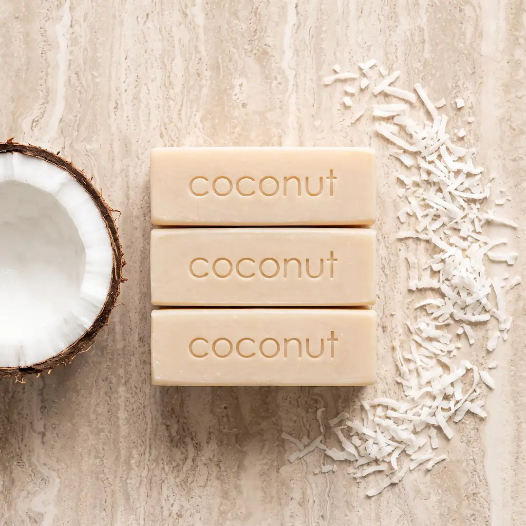 Luxury flatlay of Tasic Pure Oils Shredded Coconut Soap bars styled with cracked coconut and shredded coconut