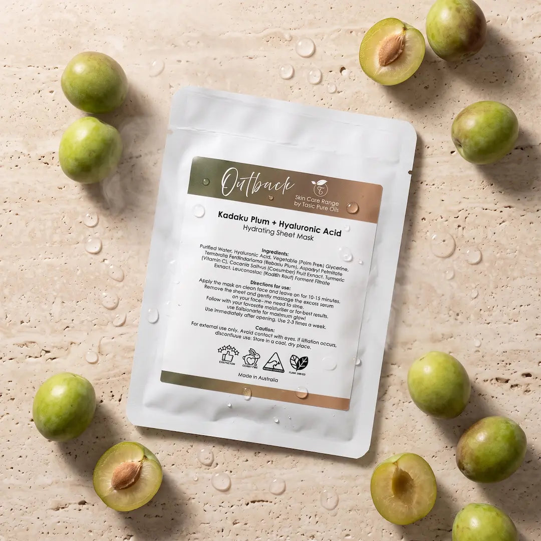 Luxury flatlay of the Tasic Pure Oils Outback Kakadu Plum and Hyaluronic Acid hydrating sheet mask styled with whole and halved Kakadu plums