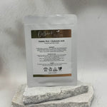 Sheet mask packaging with visible branding and product details on a stone surface.