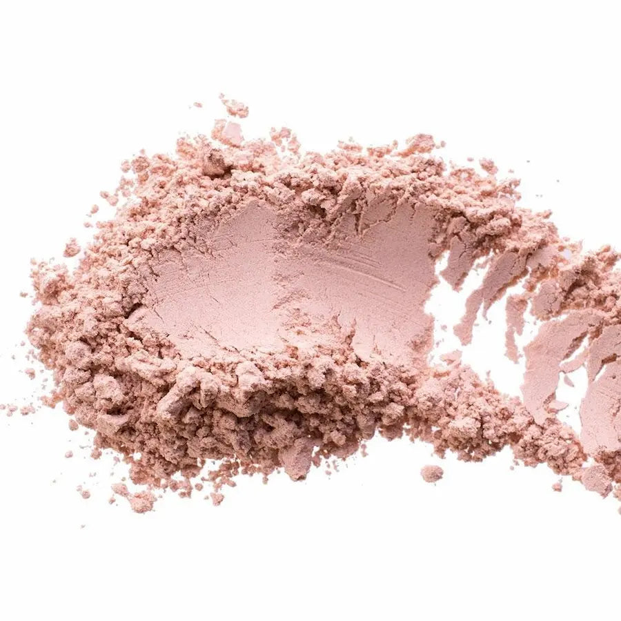 Pink makeup powder on a white background