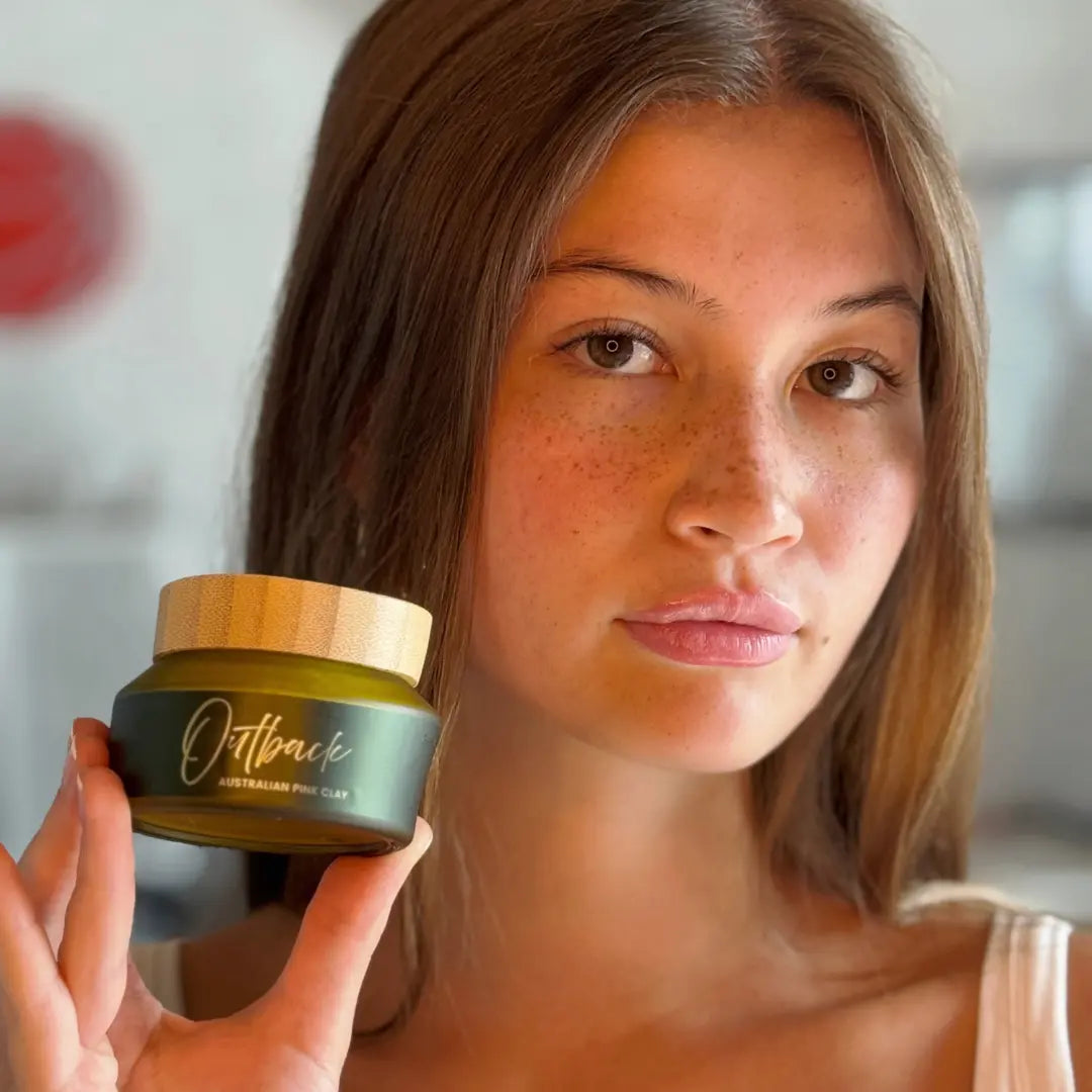 Woman holding a jar of Outback skincare product