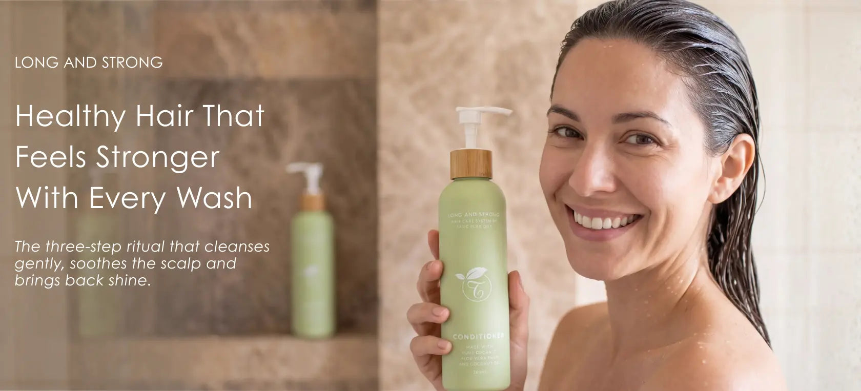 A smiling woman with wet hair holds a light green shampoo bottle in a bathroom setting. Text on the left reads, 'LONG AND STRONG Healthy Hair That Feels Stronger With Every Wash.