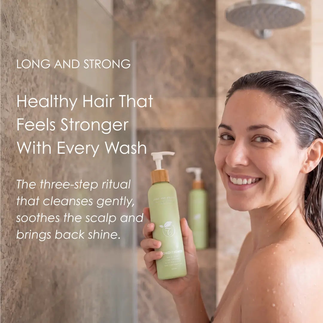 A woman in a shower holds a light green pump bottle of hair care product. The image includes marketing text on the left and shows the product in a real bathroom environment, making the subject type Lifestyle.